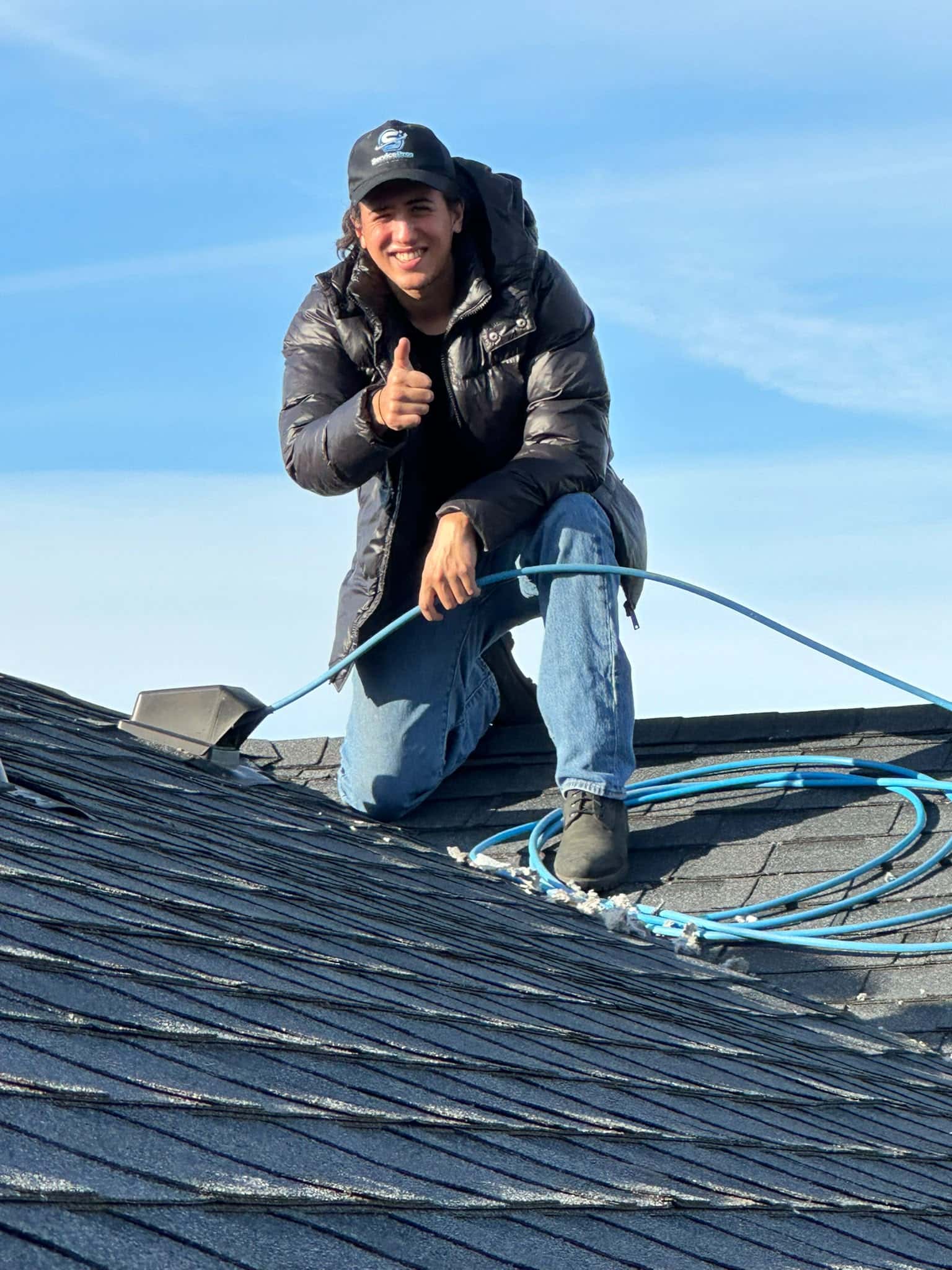 ServicePros technician beside a rooftop vent